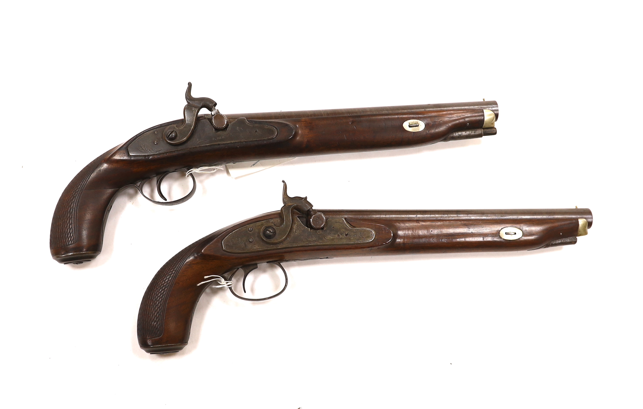 A pair of 12 bore percussion pistols converted from percussion sporting guns, round twist barrels, locks stamped G. Day, iron mounts with nickel fore-end caps and chequered grips